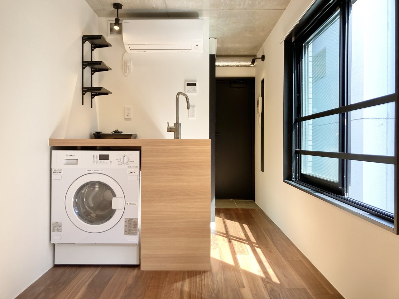 ドラム式洗濯機がキッチンに備え付けられ、スペースが上手く活用されていますね。